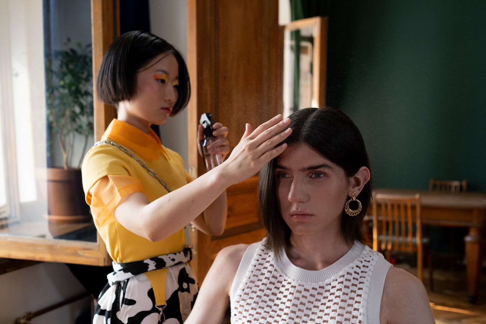 A stylist preparing a client's hair before a service